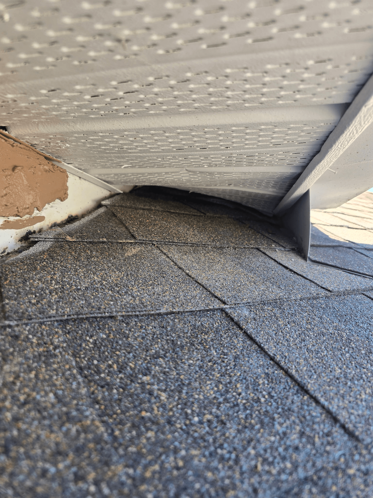 Open soffit gap before exclusion — active wildlife entry point
